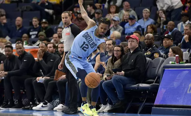 Memphis Grizzlies guard Ja Morant (12) tries to stay inbounds in the first half of an Emirates NBA Cup basketball game against the New Orleans Pelicans, Friday, Nov. 29, 2024, in Memphis, Tenn. (AP Photo/Brandon Dill)