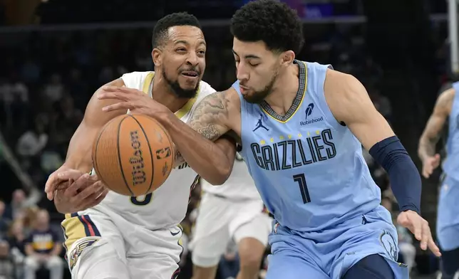 Memphis Grizzlies guard Scotty Pippen Jr. (1) defends against New Orleans Pelicans guard CJ McCollum, left, in the first half of an Emirates NBA Cup basketball game Friday, Nov. 29, 2024, in Memphis, Tenn. (AP Photo/Brandon Dill)