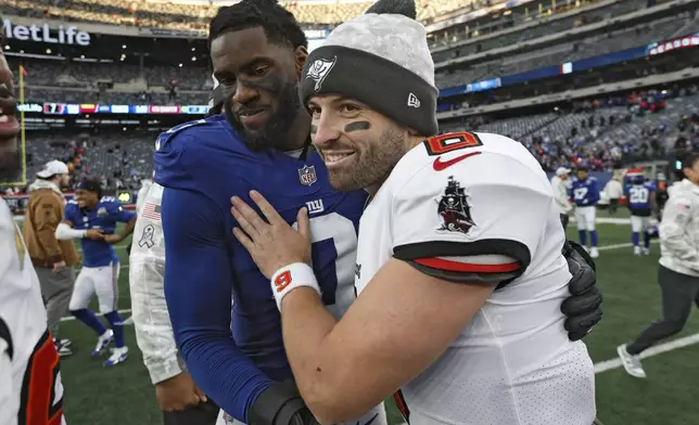 Tampa Bay Buccaneers quarterback Baker Mayfield (6) meets with New York Giants linebacker Brian Burns (0) after an NFL football game Sunday, Nov. 24, 2024, in East Rutherford, N.J. (AP Photo/Rich Schultz)