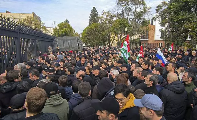 In this photo taken from video released by AIASHARA Independent Agency, Protesters gather outside the parliament building of the Georgian separatist region of Abkhazia as tensions flared over a proposed pact that would allow Russians to buy apartments in the region, Georgia, on Friday, Nov. 15, 2024. (AIASHARA Independent Agency via AP)