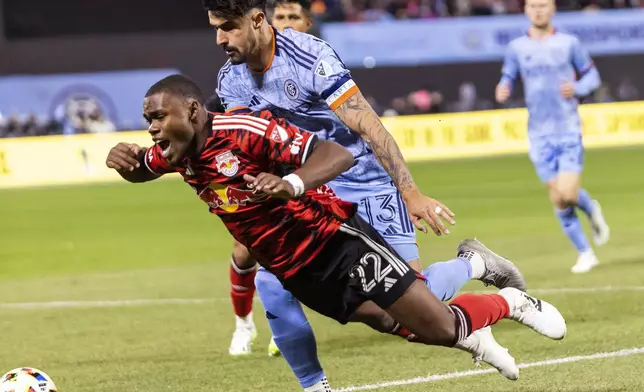 New York Red Bulls Serge Ngoma, front, fights for the ball with New York City FC defender Thiago Martins during an MLS Cup semifinal soccer match, Saturday, Nov. 23, 2024, in New York. (AP Photo/Eduardo Munoz Alvarez)