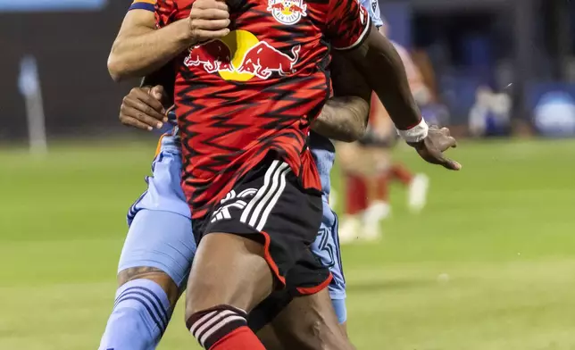 New York Red Bulls Serge Ngoma, front, fights for the ball with New York City FC defender Thiago Martins during an MLS Cup semifinal soccer match, Saturday, Nov. 23, 2024, in New York. (AP Photo/Eduardo Munoz Alvarez)