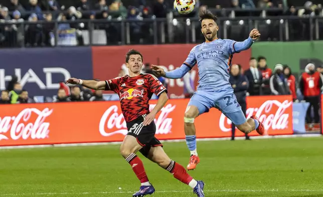 New York City FC forward Kevin O'Toole, right, fights for the ball with New York Red Bulls forward Dante Vanzeir during an MLS Cup semifinal soccer match, Saturday, Nov. 23, 2024, in New York. (AP Photo/Eduardo Munoz Alvarez)