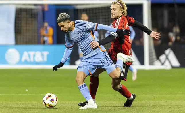 New York Red Bulls midfielder Emil Forsberg, right, fights for the ball against New York City FC forward Santiago Rodriguez during the first half of an MLS Cup semifinal soccer match, Saturday, Nov. 23, 2024, in New York. (AP Photo/Eduardo Munoz Alvarez)