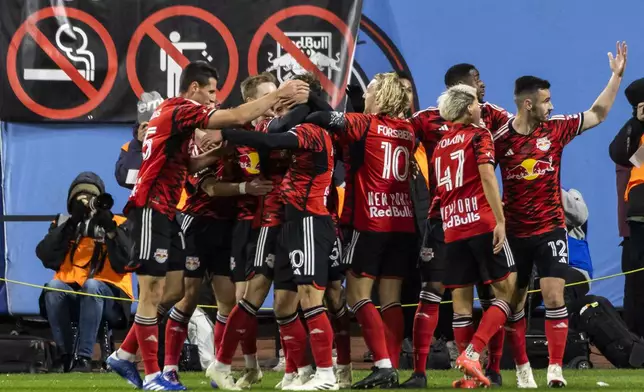 New York Red Bulls players celebrate a goal by Felipe Carballo against New York City FC during the first half of an MLS Cup semifinal soccer match, Saturday, Nov. 23, 2024, in New York. (AP Photo/Eduardo Munoz Alvarez)