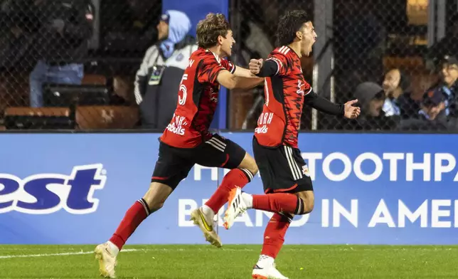 New York Red Bulls players Daniel Edelman, left, and Felipe Carballo celebrate a goal by Carballo during the first half of an MLS Cup semifinal soccer match against New York City FC, Saturday, Nov. 23, 2024, in New York. (AP Photo/Eduardo Munoz Alvarez)