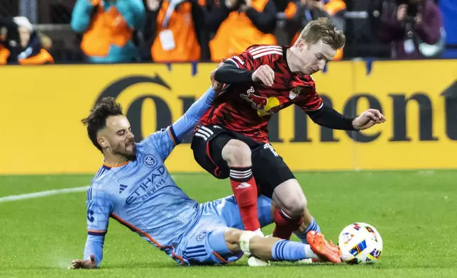 New York Red Bulls defender Cameron Harper, right, is tackled from behind by New York City FC forward Kevin O'Toole during the first half of an MLS Cup semifinal soccer match, Saturday, Nov. 23, 2024, in New York. (AP Photo/Eduardo Munoz Alvarez)