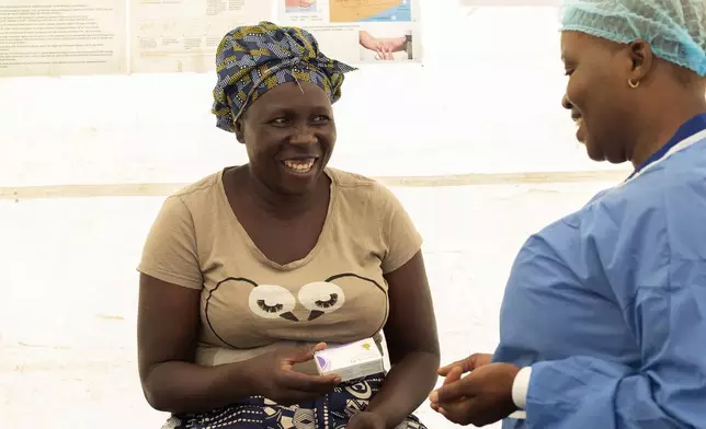 41 year old Catherine Tavaruva receives contraceptive pills at an outreach clinic in Epworth, Zimbabwe, Thursday, Nov. 14, 2024. (AP Photo/Aaron Ufumeli)