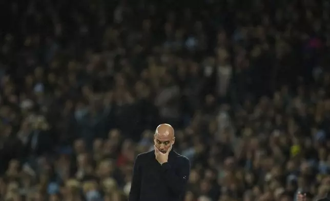 Manchester City's head coach Pep Guardiola reacts during the English Premier League soccer match between Manchester City and Tottenham at the Etihad Stadium in Manchester, England, Sunday, Nov. 24, 2024. (AP Photo/Dave Thompson)