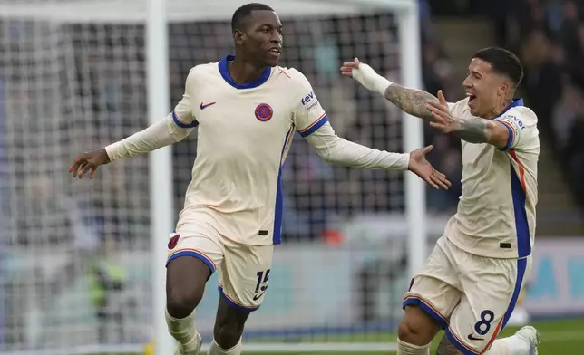 Chelsea's Nicolas Jackson, left, celebrates after scoring the opening goal during the English Premier League soccer match between Leicester City and Chelsea at King Power stadium in Leicester, England, Saturday, Nov. 23, 2024. (AP Photo/Dave Shopland)