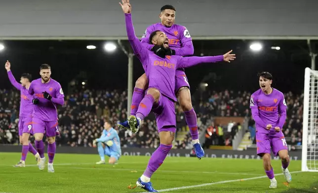 Wolverhampton Wanderers' Matheus Cunha, centre, celebrates after scoring his sides third goal during the English Premier League match between Fulham and Wolverhampton Wanderers at Craven Cottage stadium in London, Saturday, Nov. 23, 2024. (Zac Goodwin/PA via AP)