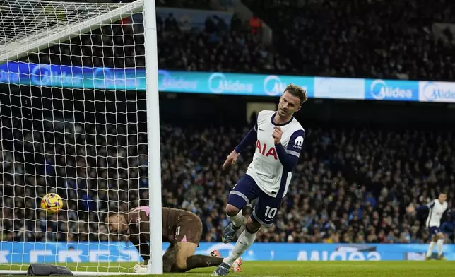 Tottenham's James Maddison scores the opening goal during the English Premier League soccer match between Manchester City and Tottenham at the Etihad Stadium in Manchester, England, Sunday, Nov. 24, 2024. (AP Photo/Dave Thompson)