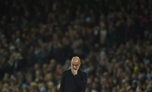 Manchester City's head coach Pep Guardiola reacts during the English Premier League soccer match between Manchester City and Tottenham at the Etihad Stadium in Manchester, England, Sunday, Nov. 24, 2024. (AP Photo/Dave Thompson)