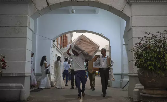 Polling workers return to a counting center with a ballot box at the end of the polling in the parliamentary election in Colombo, Sri Lanka, Thursday, Nov. 14, 2024. (AP Photo/Eranga Jayawardena)