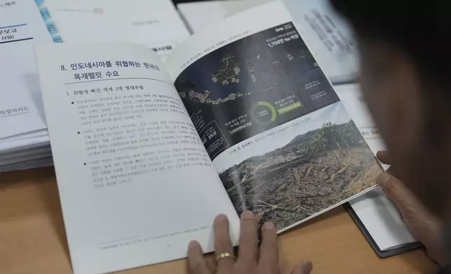 South Korean National Assembly member Moon Dae-Lim, looks at a policy report on the state audit authored by him at his office of the National Assembly in Seoul, South Korea, Wednesday, Nov. 27, 2024. (AP Photo/Lee Jin-man)