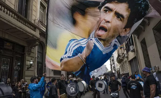 FILE - Fans gather to celebrate the anniversary of the "Hand of God" goal and the "Goal of the Century" scored by soccer legend Diego Maradona against England during the 1986 World Cup quarterfinals, in Buenos Aires, Argentina, June 22, 2024. (AP Photo/Rodrigo Abd, File)