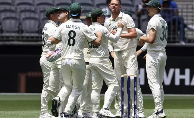 Australia's Josh Hazlewood, facing the camera, celebrates with teammates the wicket of India's Devdutt Padikkal during play in the first cricket test between India and Australia in Perth, Australia, Friday, Nov. 22, 2024. (AP Photo/Trevor Collens)