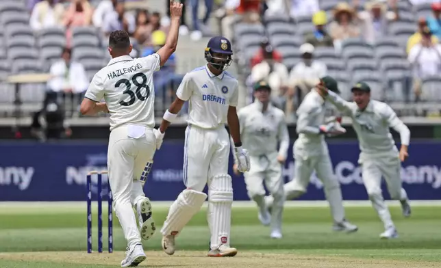 Australia's Josh Hazlewood celebrates the wicket of India's Devdutt Padikkal, second left, during play in the first cricket test between India and Australia in Perth, Australia, Friday, Nov. 22, 2024. (AP Photo/Trevor Collens)