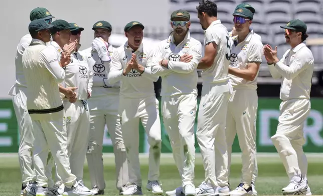 Australia's players celebrate the wicket of India's KL Rahul during play in the first cricket test between India and Australia in Perth, Australia, Friday, Nov. 22, 2024. (AP Photo/Trevor Collens)