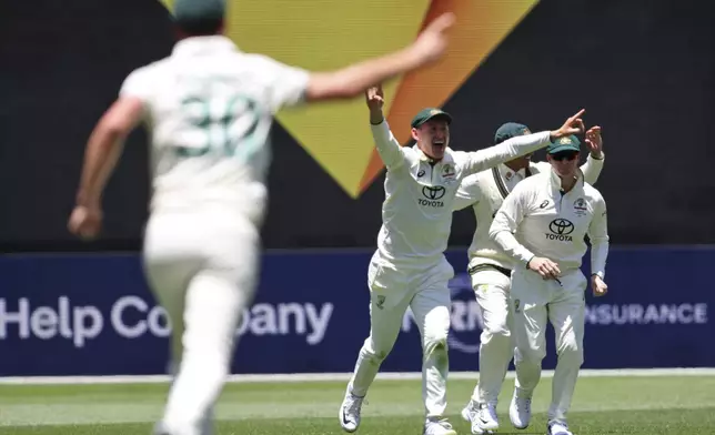 Australia's players celebrate the wicket of India's Virat Kohli during play in the first cricket test between India and Australia in Perth, Australia, Friday, Nov. 22, 2024. (AP Photo/Trevor Collens)