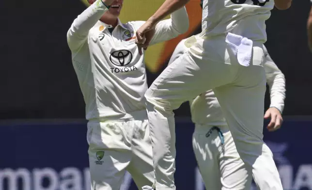 Australia's Josh Hazlewood celebrates with teammates the wicket of India's Virat Kohli during play in the first cricket test between India and Australia in Perth, Australia, Friday, Nov. 22, 2024. (AP Photo/Trevor Collens)