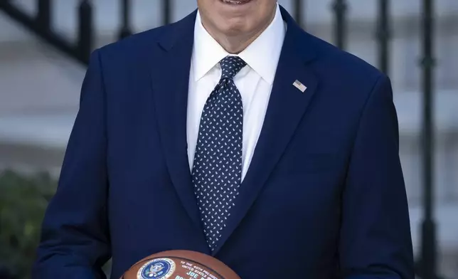 President Joe Biden holds a basketball he received from the Boston Celtics at an event to celebrate their victory in the 2024 National Basketball Association Championship, on the South Lawn of the White House in Washington, Thursday, Nov. 21, 2024. (AP Photo/Ben Curtis)