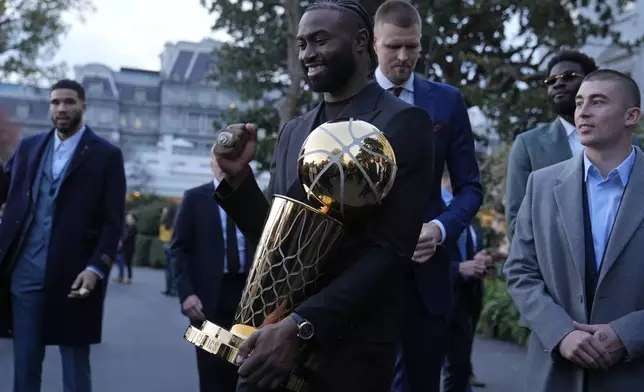 Boston Celtics player Jaylen Brown holds the Boston Celtics championship trophy following an event with President Joe Biden to celebrate the Celtics victory in the 2024 National Basketball Association Championship, on the South Lawn of the White House in Washington, Thursday, Nov. 21, 2024. (AP Photo/Susan Walsh)