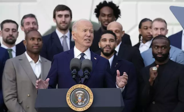 President Joe Biden, center, speaks during an event to welcome the Boston Celtics and celebrate their victory in the 2024 National Basketball Association Championship, on the South Lawn of the White House in Washington, Thursday, Nov. 21, 2024. (AP Photo/Susan Walsh)