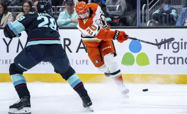 Anaheim Ducks forward Brett Leason, right, scores a goal on a shot against Seattle Kraken defenseman Joshua Mahura during the first period of an NHL hockey game, Wednesday, Nov. 27, 2024, in Seattle. (AP Photo/Stephen Brashear)