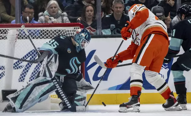 Anaheim Ducks forward Brett Leason, right, shoots the puck against Seattle Kraken goalie Joey Daccord during the second period of an NHL hockey game, Wednesday, Nov. 27, 2024, in Seattle. (AP Photo/Stephen Brashear)