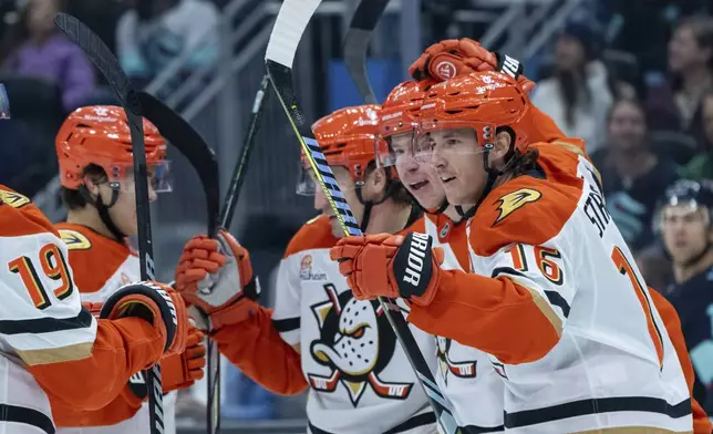 Anaheim Ducks forward Ryan Strome, right, defenseman Jackson LaCombe, second from right, forward Frank Vatrano, second from left, and defenseman Olen Zellweger celebrate a goal during the first period of an NHL hockey game against the Seattle Kraken, Wednesday, Nov. 27, 2024, in Seattle. (AP Photo/Stephen Brashear)