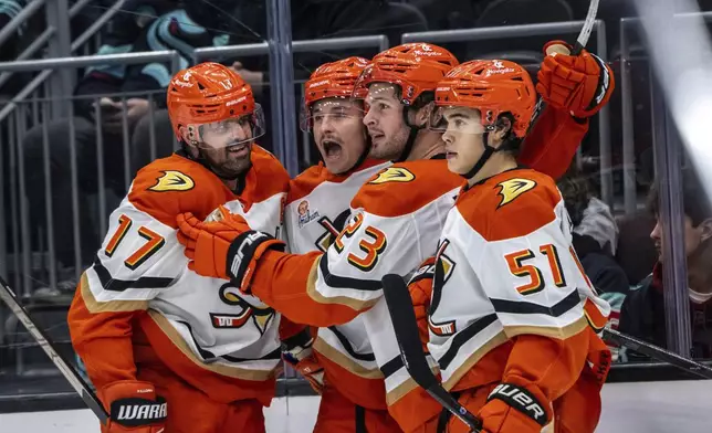 Anaheim Ducks, from left, forward Alex Killorn, forward Trevor Zegras, forward Mason McTavish and defenseman Olen Zellweger celebrates during an NHL hockey game against the Seattle Kraken, Wednesday, Nov. 27, 2024, in Seattle. The Ducks won 5-2. (AP Photo/Stephen Brashear)