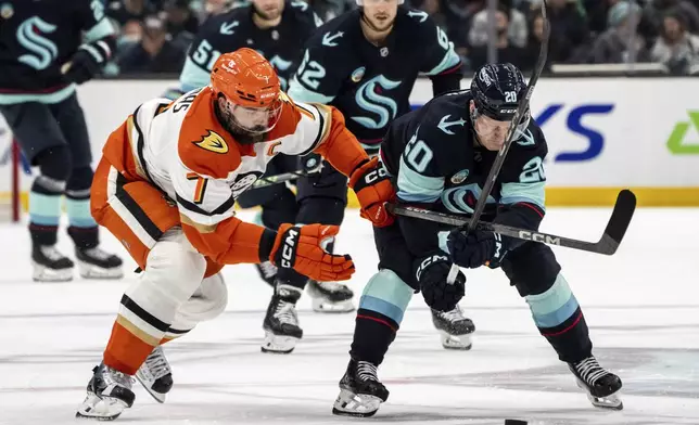 Anaheim Ducks defenseman Radko Gudas, left, and Seattle Kraken forward Eeli Tolvanen battle for puck during the second period of an NHL hockey game, Wednesday, Nov. 27, 2024, in Seattle. (AP Photo/Stephen Brashear)