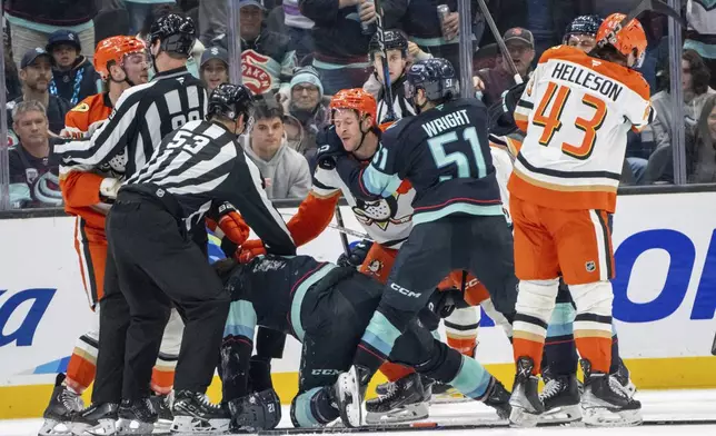 Players from the Seattle Kraken and Anaheim Ducks scuffle during the third period of an NHL hockey game, Wednesday, Nov. 27, 2024, in Seattle. The Ducks won 5-2. (AP Photo/Stephen Brashear)