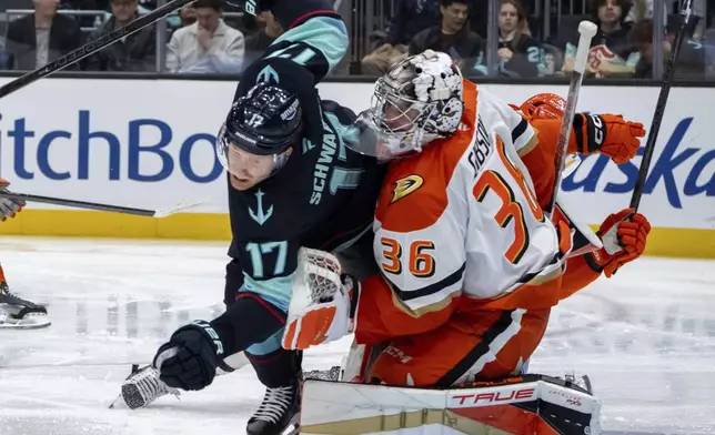 Seattle Kraken forward Jaden Schwartz, left, collides with Anaheim Ducks goalie John Gibson during the second period of an NHL hockey game, Wednesday, Nov. 27, 2024, in Seattle. (AP Photo/Stephen Brashear)