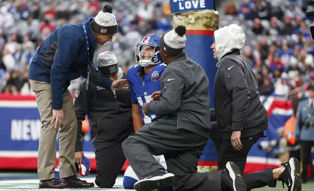 New York Giants quarterback Tommy DeVito (15) reacts after getting shaken up after a tackle during the second half of an NFL football game against the Tampa Bay Buccaneers Sunday, Nov. 24, 2024, in East Rutherford, N.J. (AP Photo/Rich Schultz)