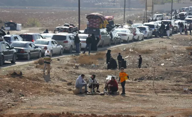 Lebanese families sit in traffic as they return to Lebanon through the Jousieh border crossing, in Qusair, Syria, Thursday, Nov. 28, 2024, following a ceasefire between Israel and Hezbollah that went into effect on Wednesday. (AP Photo/Omar Sanadiki)