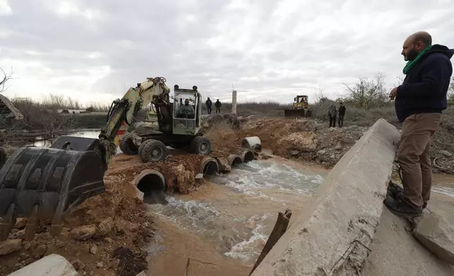 Workers repair a bridge over the Assi river in Qusair, Syria, Thursday, Nov. 28, 2024, damaged in an Israeli airstrike earlier in the month. (AP Photo/Omar Sanadiki)