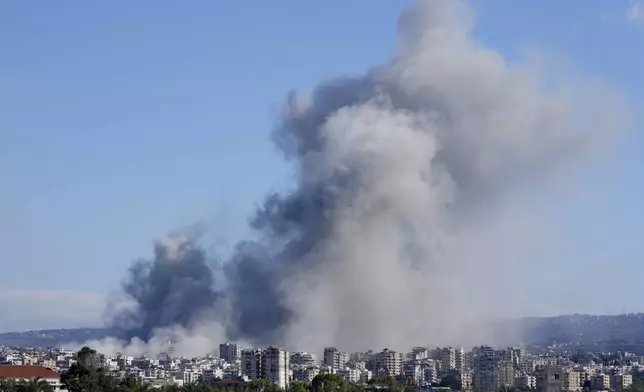 Smoke rises between buildings hit in Israeli airstrikes in Hosh neighbourhood, in Tyre, south Lebanon, Tuesday, Nov. 26, 2024. (AP Photo/Hussein Malla)