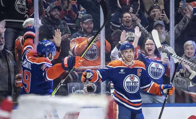 Edmonton Oilers' Connor McDavid (97) celebrates his 1000th point, against the Nashville Predators during the second period of an NHL hockey game, Thursday, Nov. 14, 2024 in Edmonton, Alberta. (Jason Franson/The Canadian Press via AP)