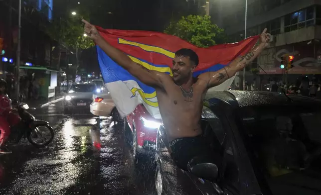 Supporters of the Broad Front (Frente Amplio) celebrate the victory of candidate Yamandú Orsi in the presidential run-off election in Montevideo, Uruguay, Sunday, Nov. 24, 2024. (AP Photo/Matilde Campodonico)