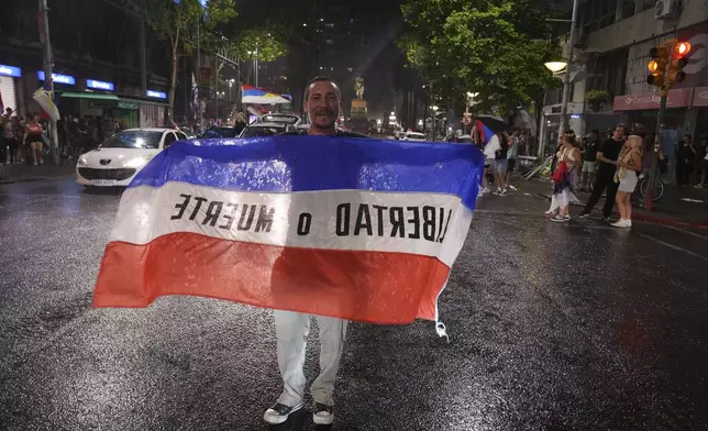 Supporters of the Broad Front (Frente Amplio) celebrate the victory of candidate Yamandú Orsi in the presidential run-off election in Montevideo, Uruguay, Sunday, Nov. 24, 2024. (AP Photo/Matilde Campodonico)