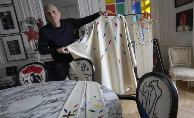 Designer Jean-Charles de Castelbajac displays a liturgical vestment for priests to be worn at the reopening of Paris' Notre-Dame cathedral in December, Wednesday, Nov. 20, 2024 in Paris. (AP Photo/Michel Euler)