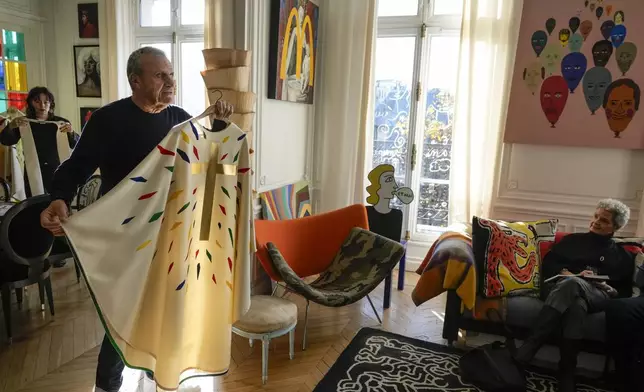 Designer Jean-Charles de Castelbajac displays a liturgical vestment for priests to be worn at the reopening of Paris' Notre-Dame cathedral in December, Wednesday, Nov. 20, 2024 in Paris. (AP Photo/Michel Euler)