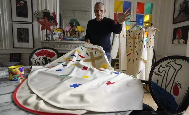 Designer Jean-Charles de Castelbajac displays a liturgical vestment for bishops to be worn at the reopening of Paris' Notre Dame Cathedral in December during an interview with the Associated Press Wednesday, Nov. 20, 2024 in Paris. (AP Photo/Michel Euler)