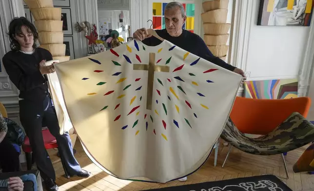 Designer Jean-Charles de Castelbajac displays a liturgical vestment for priests and to be worn at the reopening of Paris' Notre-Dame Cathedral in December, Wednesday, Nov. 20, 2024 in Paris. (AP Photo/Michel Euler)