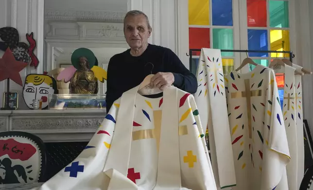 Designer Jean-Charles de Castelbajac displays a liturgical vestment for bishops to be worn at the reopening of Paris' Notre-Dame Cathedral in December, Wednesday, Nov. 20, 2024 in Paris. (AP Photo/Michel Euler)