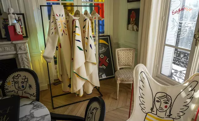 Liturgical vestments for bishops and priests designed by Jean-Charles de Castelbajac and to be worn at the reopening of Paris' Notre Dame Cathedral in December hang, Wednesday, Nov. 20, 2024 in Paris. (AP Photo/Michel Euler)