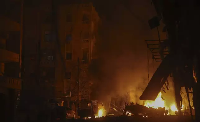 Vehicles burn after an airstrike against opposition fighters in Aleppo, Syria, late Friday, Nov. 29, 2024. (AP Photo/Ghaith Alsayed)