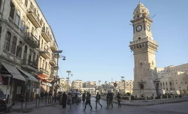 Syrian opposition fighters patrol along the streets of Aleppo, Syria, Saturday Nov. 30, 2024. (AP Photo/Ghaith Alsayed)